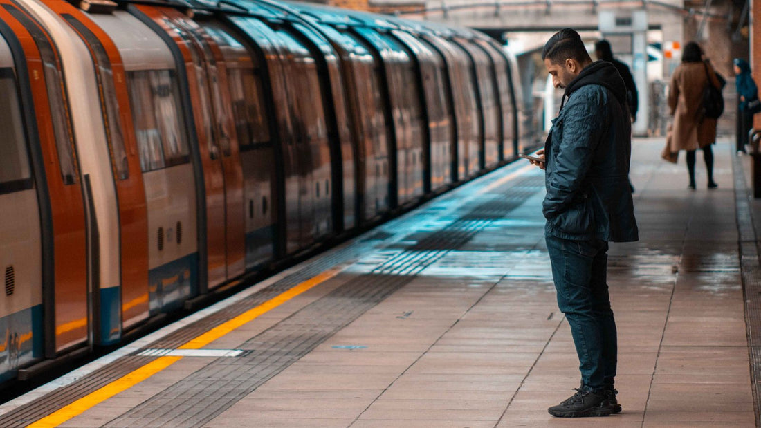 Commuter waiting calmly on a London Underground platform as a train pulls in